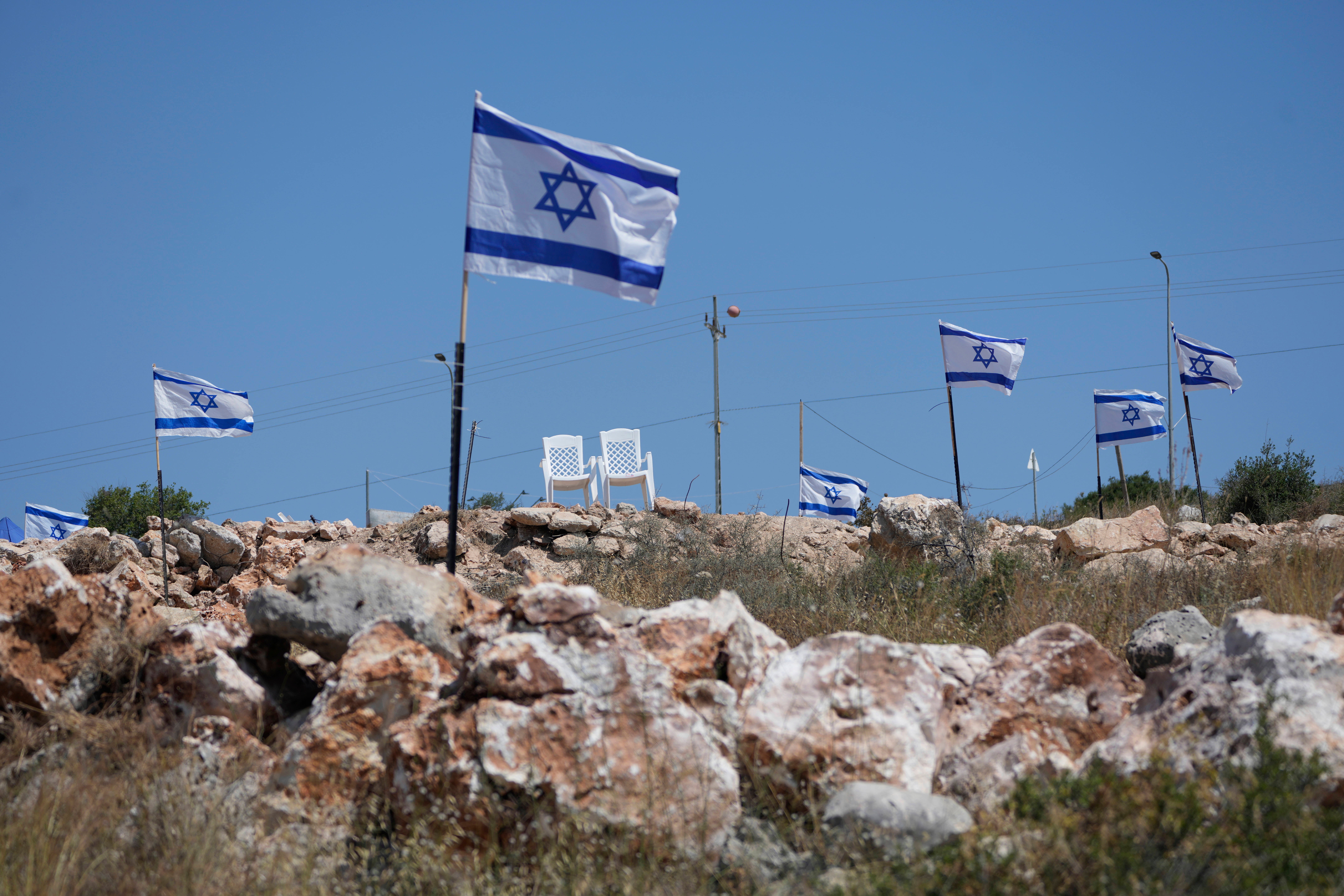 Israeli flags fly adjacent to Palestinian properties that were under attack by Israeli settlers in May