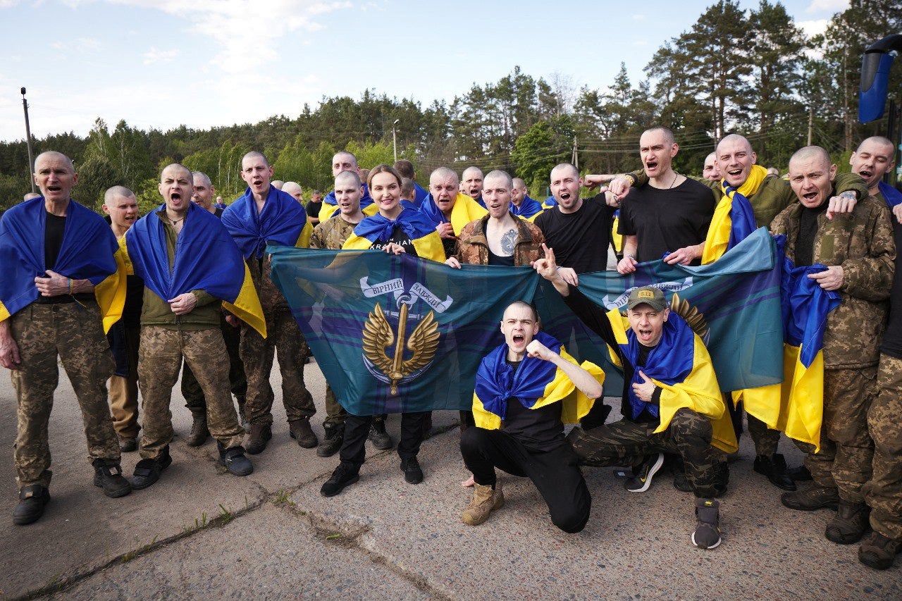 Ukrainian POWs at an unknown location after being exchanged by Russia
