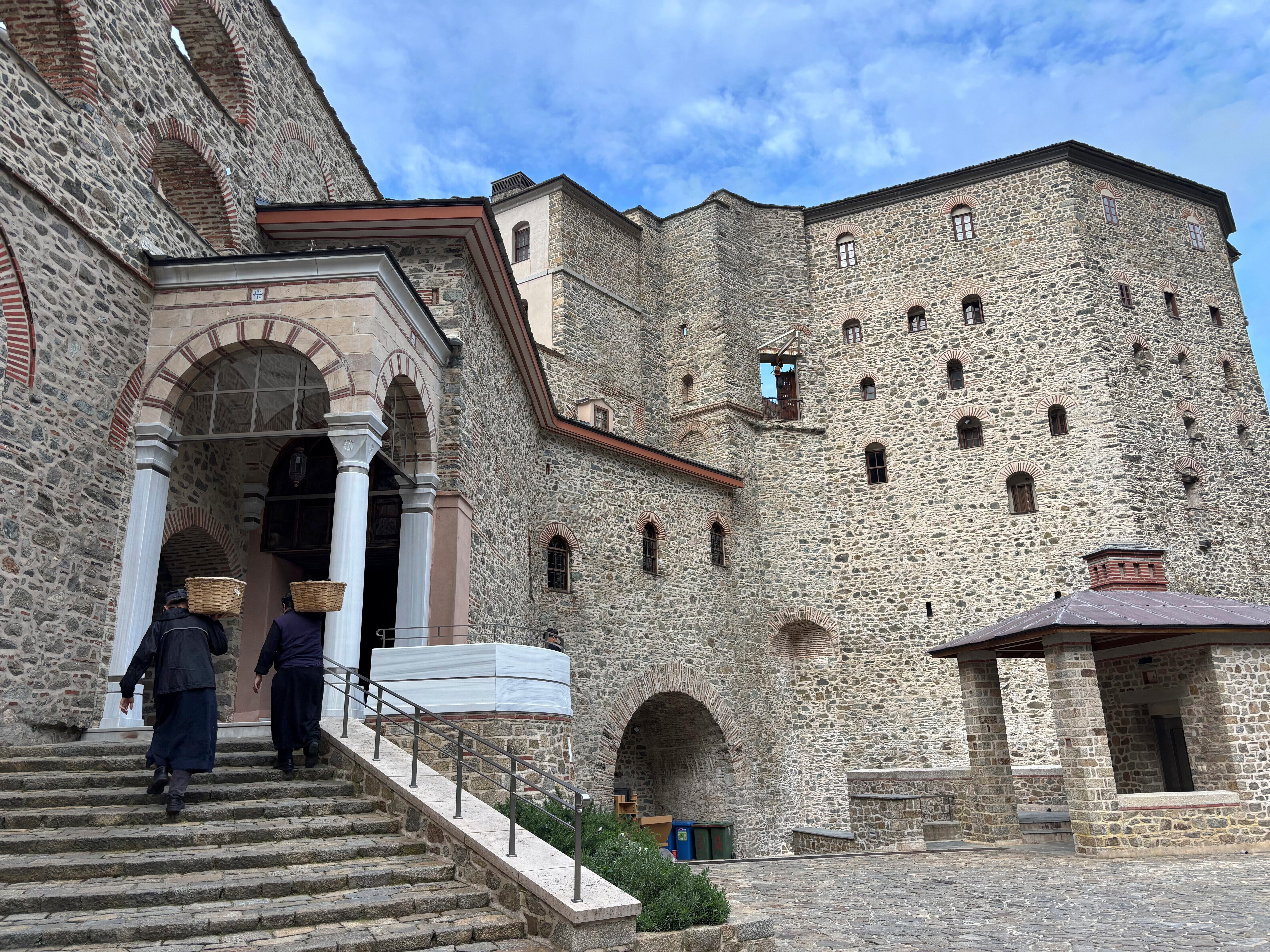 Monks carry baskets of supplies to the Simonopetra, or Simonos Petra Monastery, home of the all-male autonomous community of Agion Oros, or Holy Mountain, on the peninsula of Mount Athos in northern Greece,, Tuesday, April 15, 2025. (AP Photo/Thanassis Stavrakis, file)