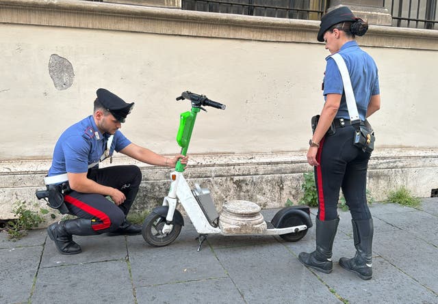 <p>Police inspect a 30kg marble artefact stolen by a German tourist using a Lime electric scooter </p>