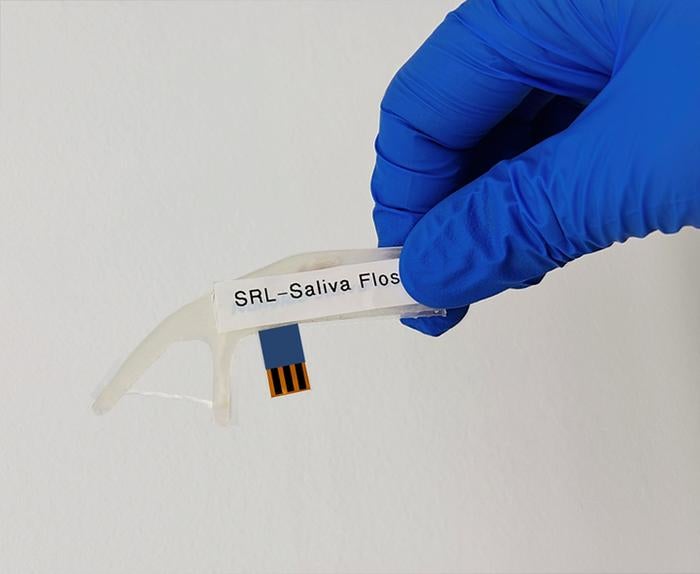 The engineered dental floss pick has one string stretched across two prongs, like normal floss picks. However, it also has biosensors that can detect cortisol