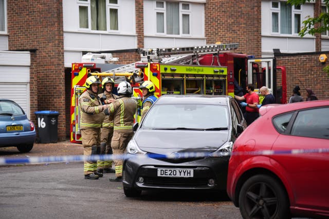 <p>Police and firefighters remain at the scene in Tillett Close, Stonebridge (James Manning/PA)</p>