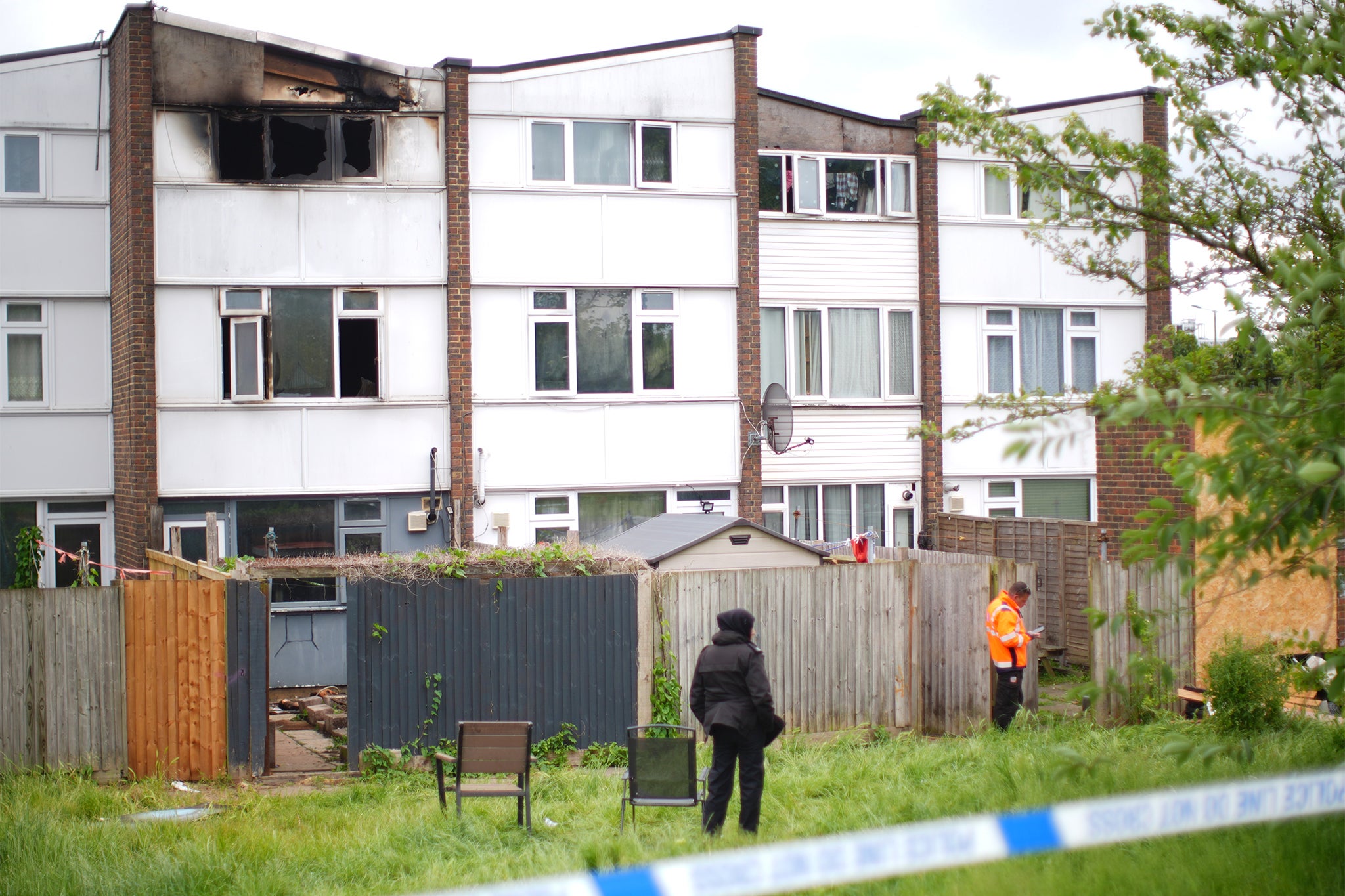 The scene at the rear of the terraced homes in Tillett Close, following the house fire