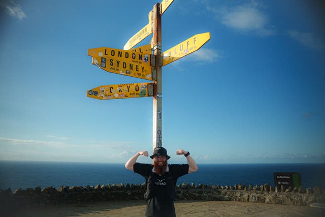 Russ Cook crossing the finish line at Cape Reinga in Northland at the top of New Zealand (Toby Jones/PA)