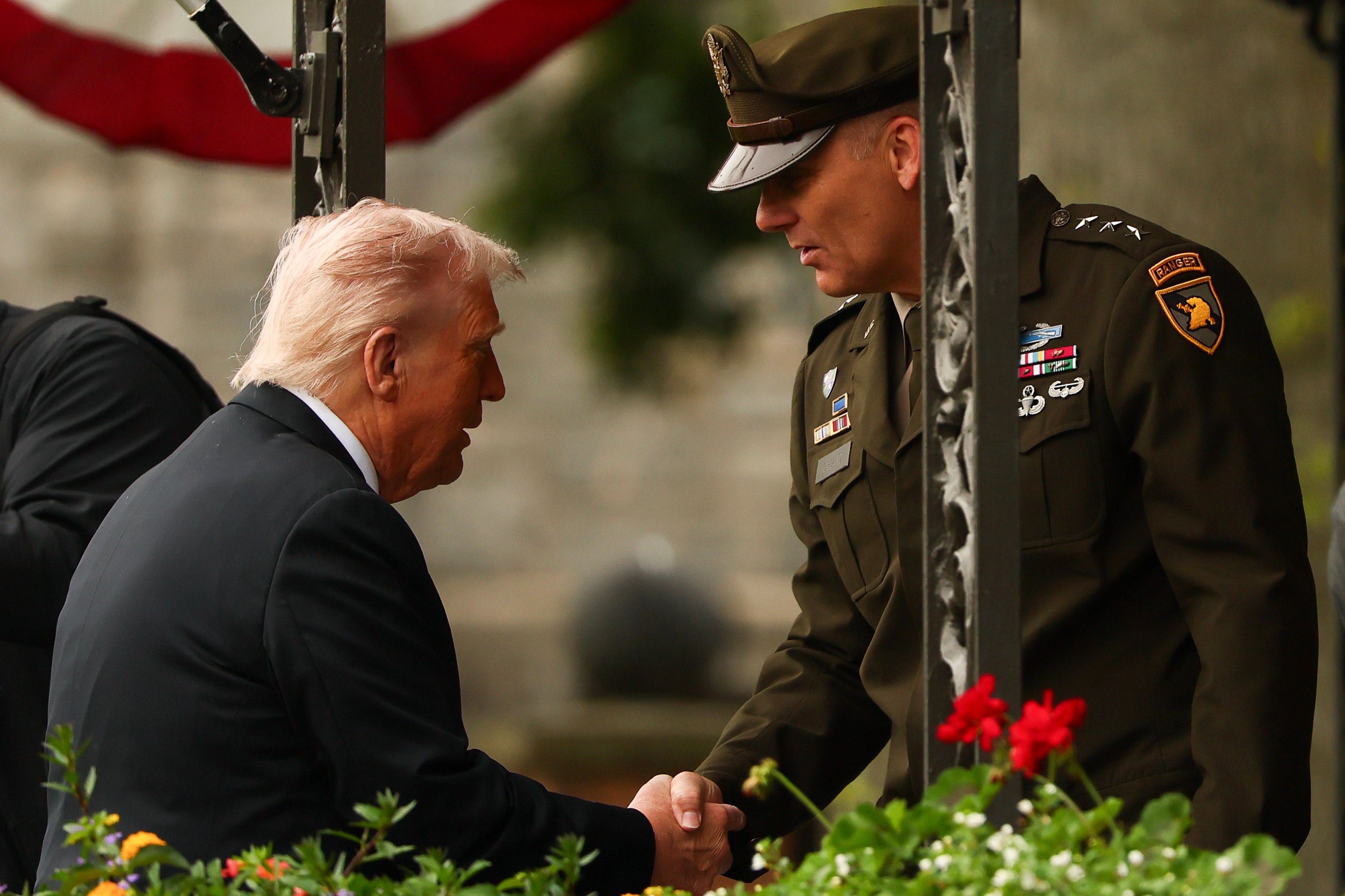 Trump shakes hands with West Point superintendent Steven W. Gilland. The president rambled about a retired golf player and a dead real estate mogul in his address
