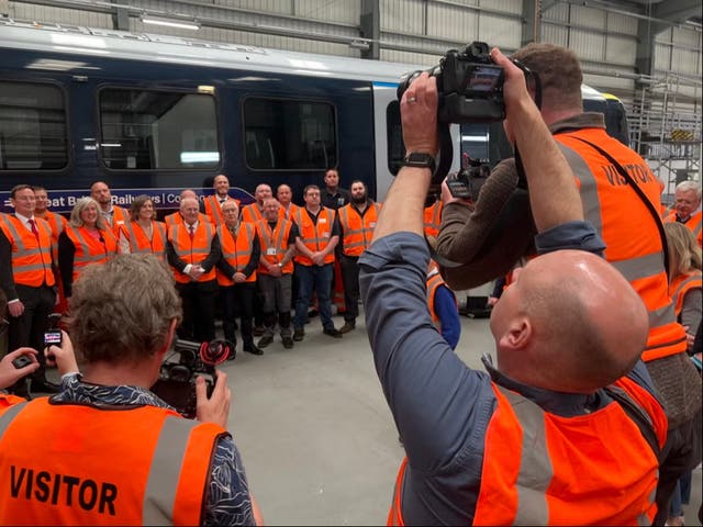 <p>High visibility: Politicians and officials at the ‘reveal’ of the first Great British Railways-branded train</p>