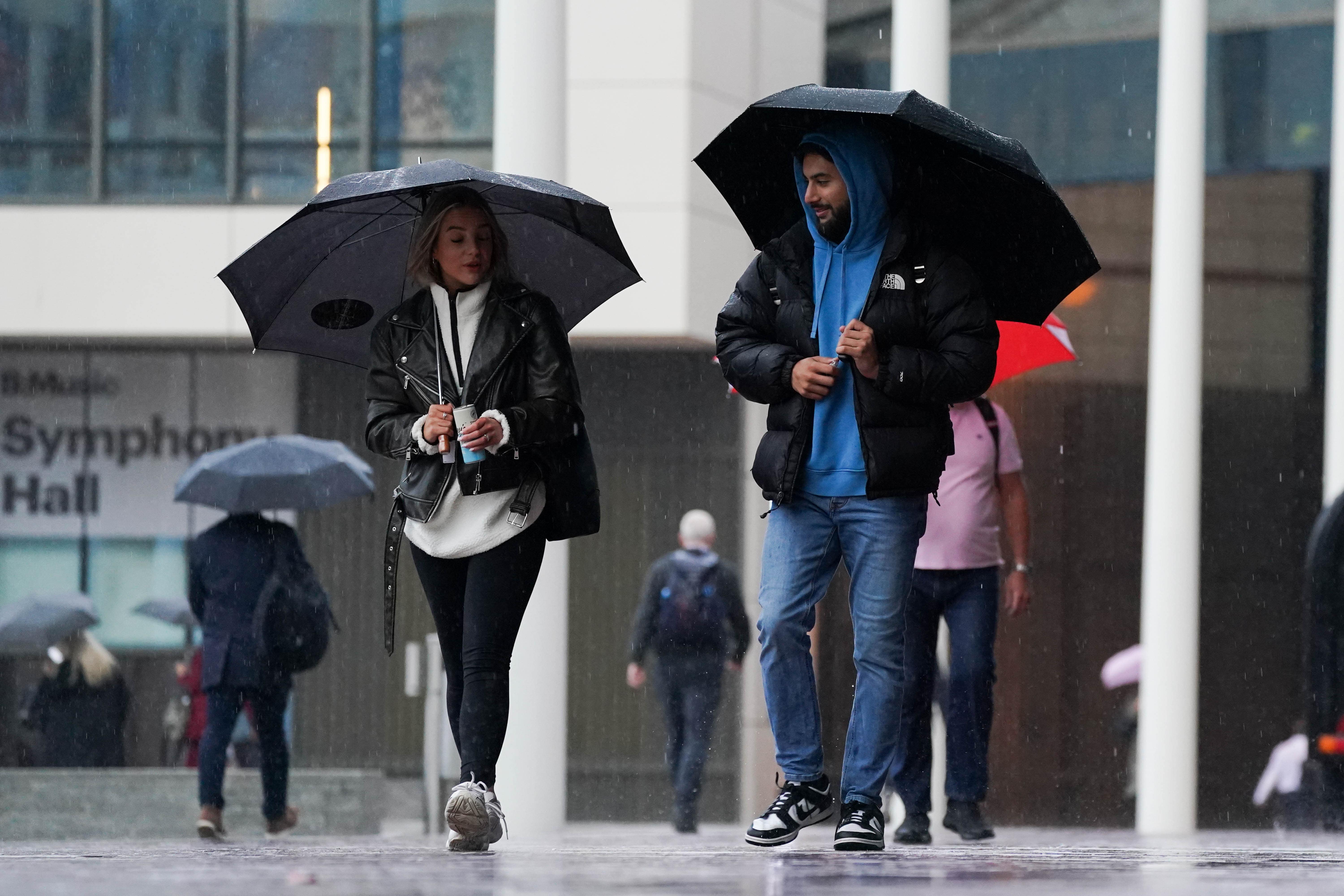People walk by Centenary Square in Birmingham during a rainy morning. Strong winds and heavy rain are set to batter the UK as Storm Agnes sweeps across the country. Agnes, the first named storm of the season, will affect western regions of the UK and Ireland on Wednesday, with the most powerful winds expected on the Irish Sea coasts. Picture date: Tuesday September 26, 2023.