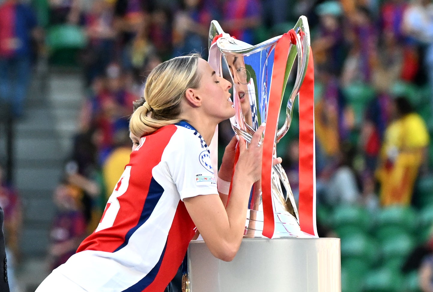 Chloe Kelly kisses the Women’s Champions League trophy