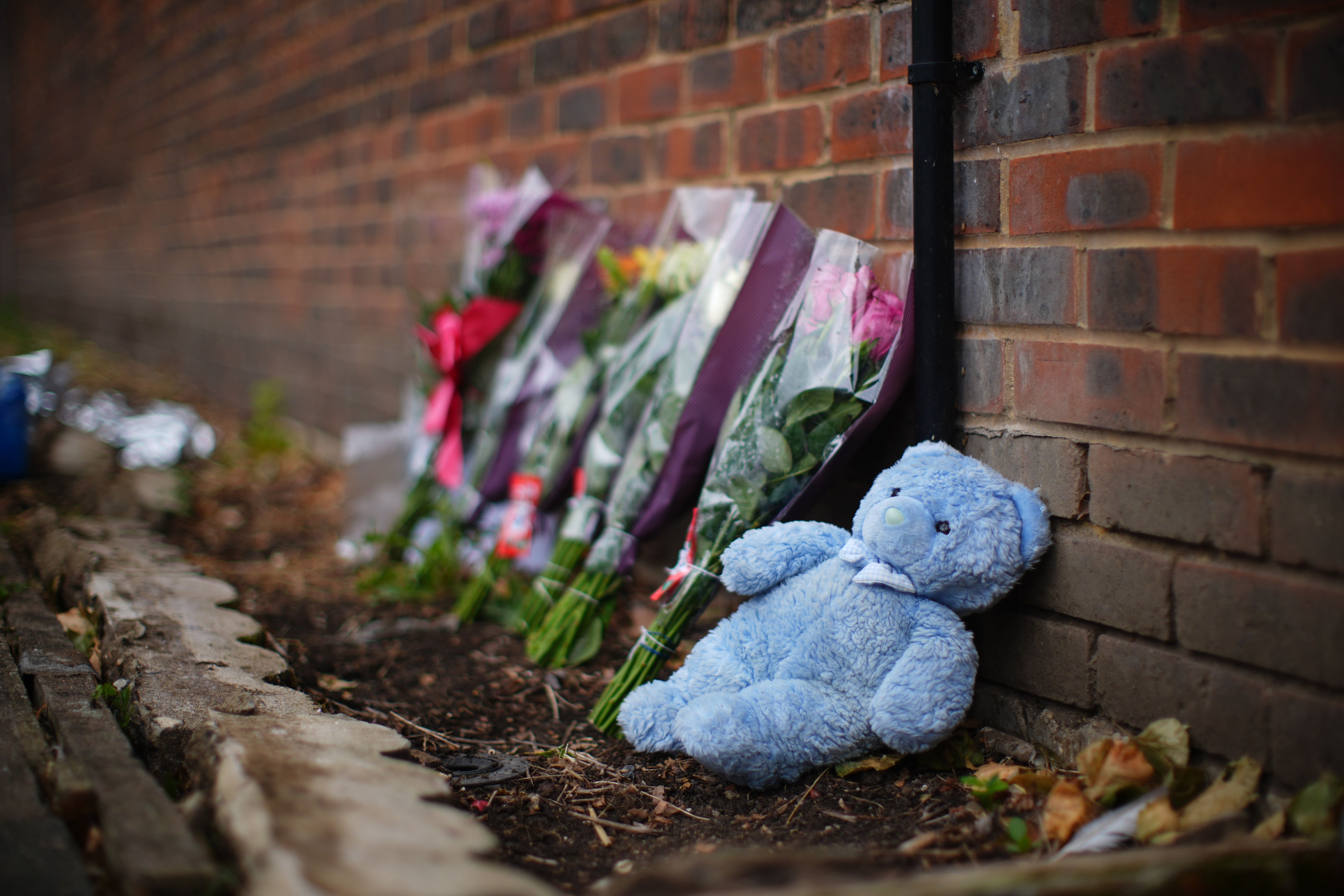 Floral tributes were left near the scene where the mother and three of her children died after a house fire