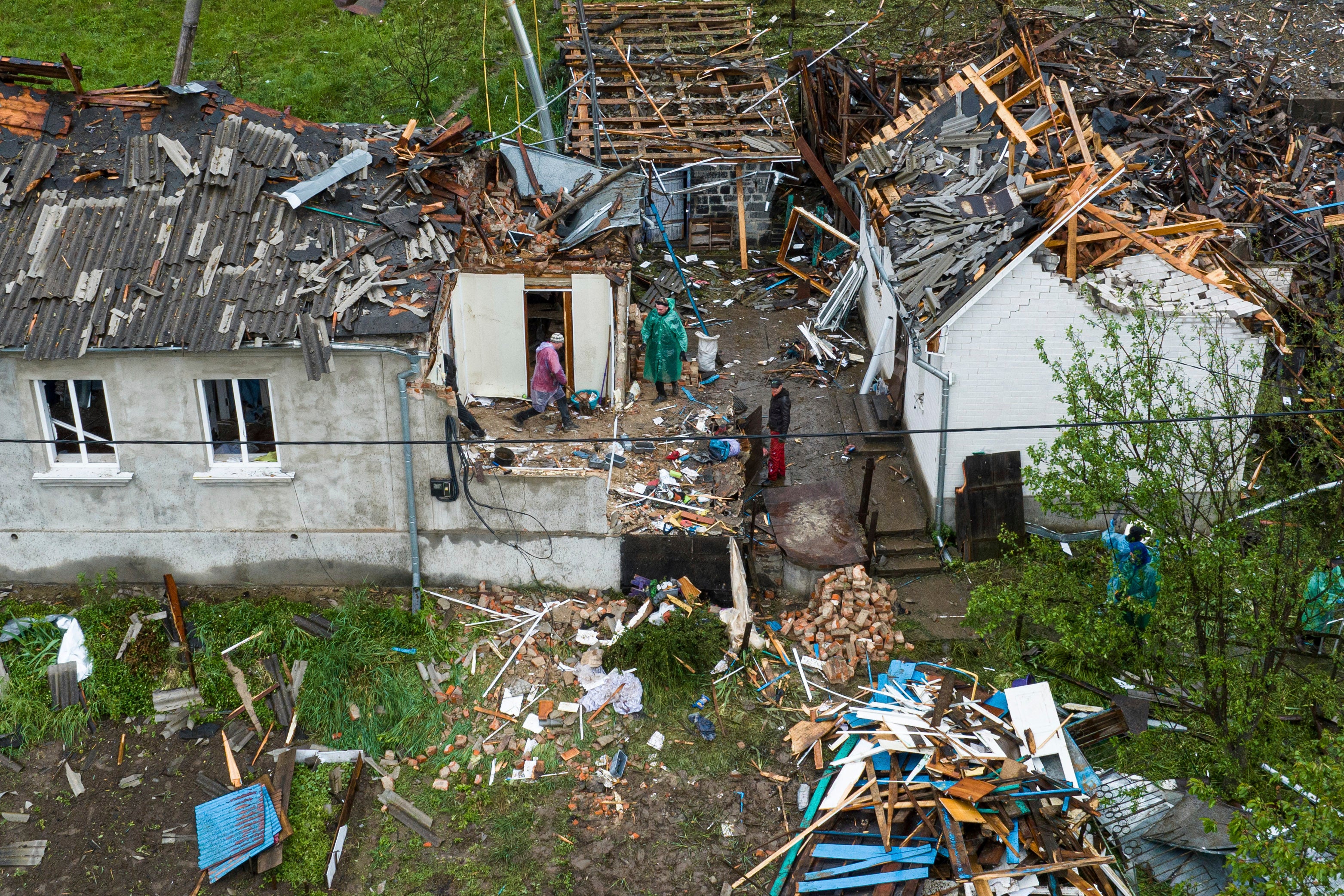 People clear the rubble of houses destroyed by a Russian strike in Korostyshiv, Zhytomyr region