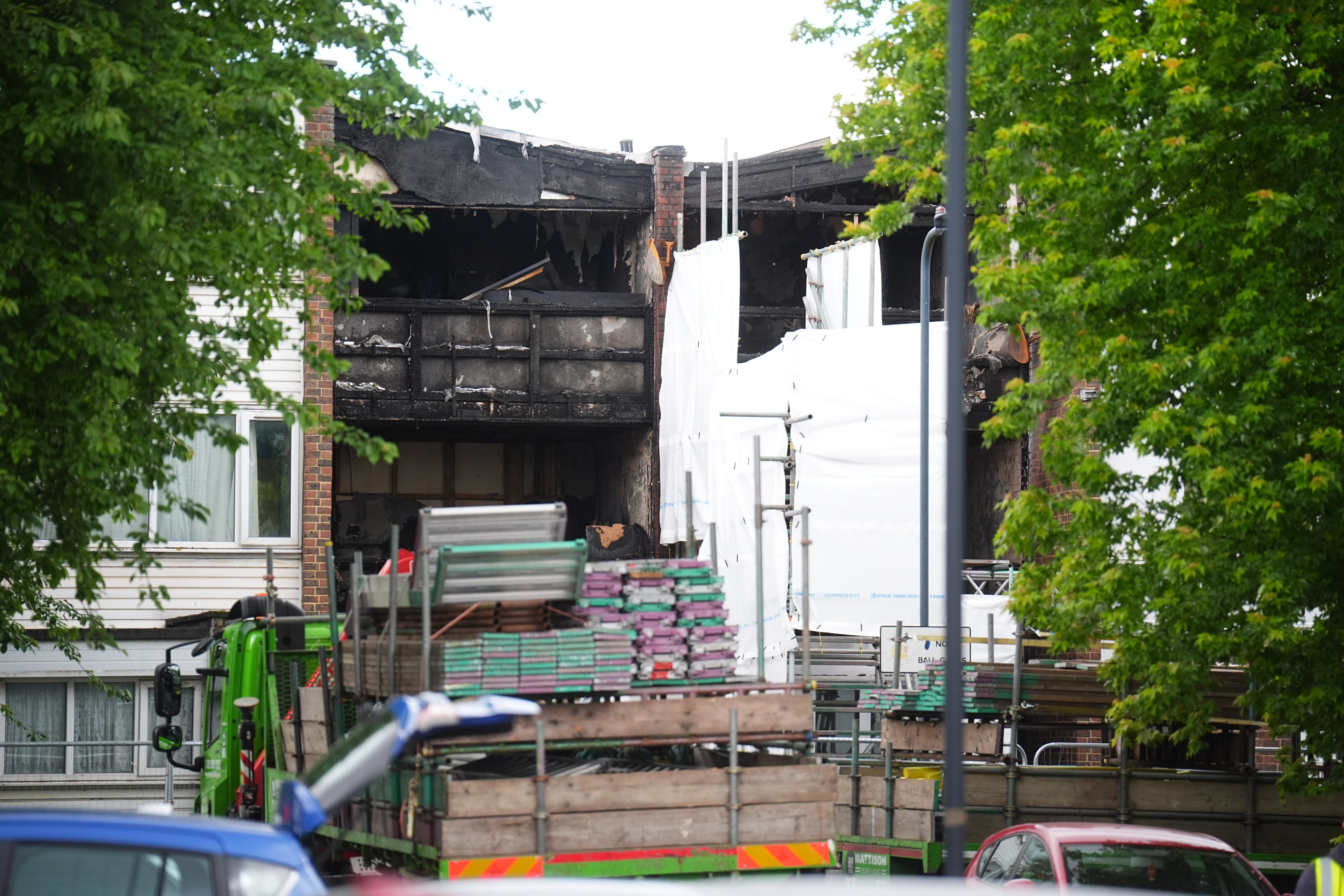 Scaffolding is erected at the properties in Tillett Close, Stonebridge, in Brent, as police investigate the blaze