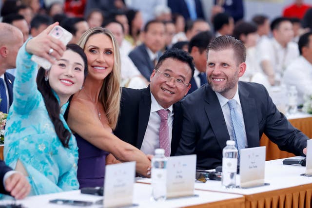<p>Eric Trump (R), son of US President Donald Trump, and his wife Lara Trump (2nd L) take a selfie as they attend the groundbreaking ceremony for the Trump International, Hung Yen resort and golf course project in Hung Yen province on May 21, 2025</p>
