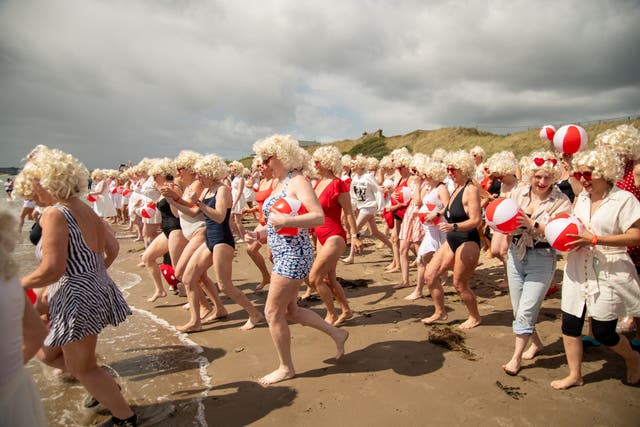 Almost 200 participants of Marilyn’s Mater Paddle run into the water at Balcarrick Beach in Donabate, Co Dublin (Celine Nic Oireachtaigh/PA)