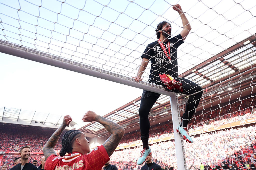 <p>Alisson Becker of Liverpool  celebrates on top of the goal, as Liverpool are crowned the Champions of the Premier League for the 2024/25 Season</p>