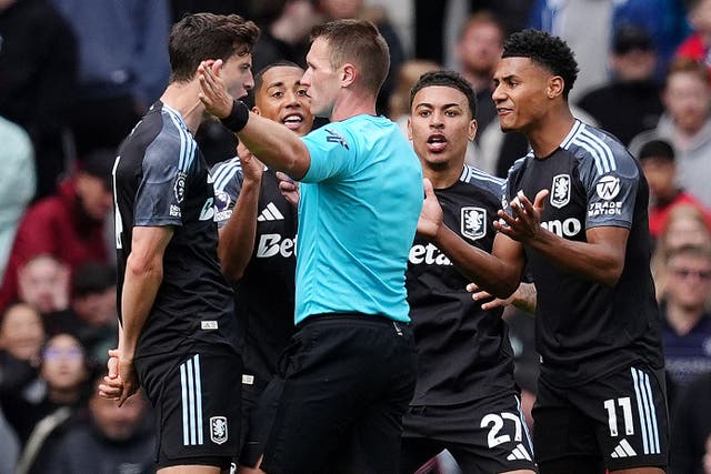 Morgan Rogers, centre right, and his Aston Villa team-mates protest to referee Thomas Bramall, centre, after he disallowed Rogers’ goal against Manchester United (Martin Rickett/PA)