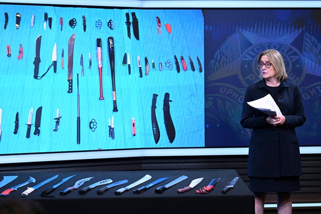 <p>Victorian state Premier Jacinta Allan looks at a display of machetes during an announcement at Victoria Police Headquarters in Melbourne, Australia, Thursday, March 13, 2025. (James Ross/AAP Image via AP)</p>