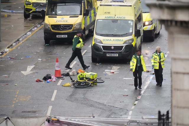 <p>Police and emergency personnel dealing with a road traffic accident on Water Street near the Liver Building in Liverpool after a car collided with pedestrians during the Premier League winners parade. A man has been detained</p>