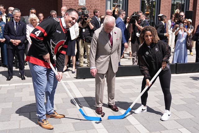 The King puts down the puck for the start of a game of hockey during a visit to a community event at Lansdowne Park in Ottawa (Aaron Chown/PA)