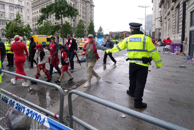 <p>Fans leave as Police and emergency personnel deal with an incident near the Liver Building during the Premier League winners parade in Liverpool, England, Monday, May 26, 2025</p>