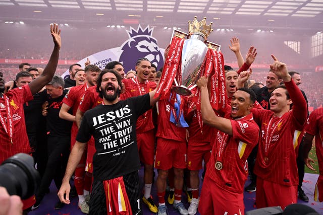<p>Alisson Becker and Trent Alexander-Arnold of Liverpool  celebrate with Premier League trophy, </p>