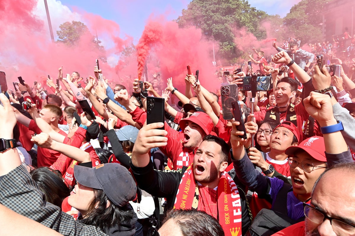 Liverpool fans celebrate winning the Premier League title win -  (EPA)