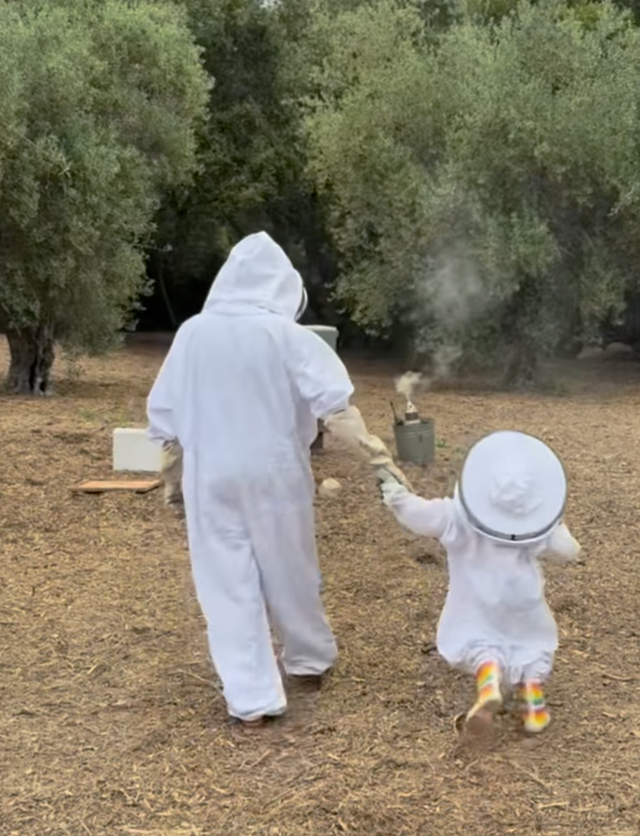 <p>Meghan with her daughter Lilibet in beekeeping outfits</p>