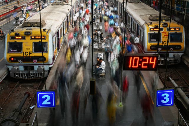 <p>Commuters walk on platforms at Churchgate train station in Mumbai, India</p>