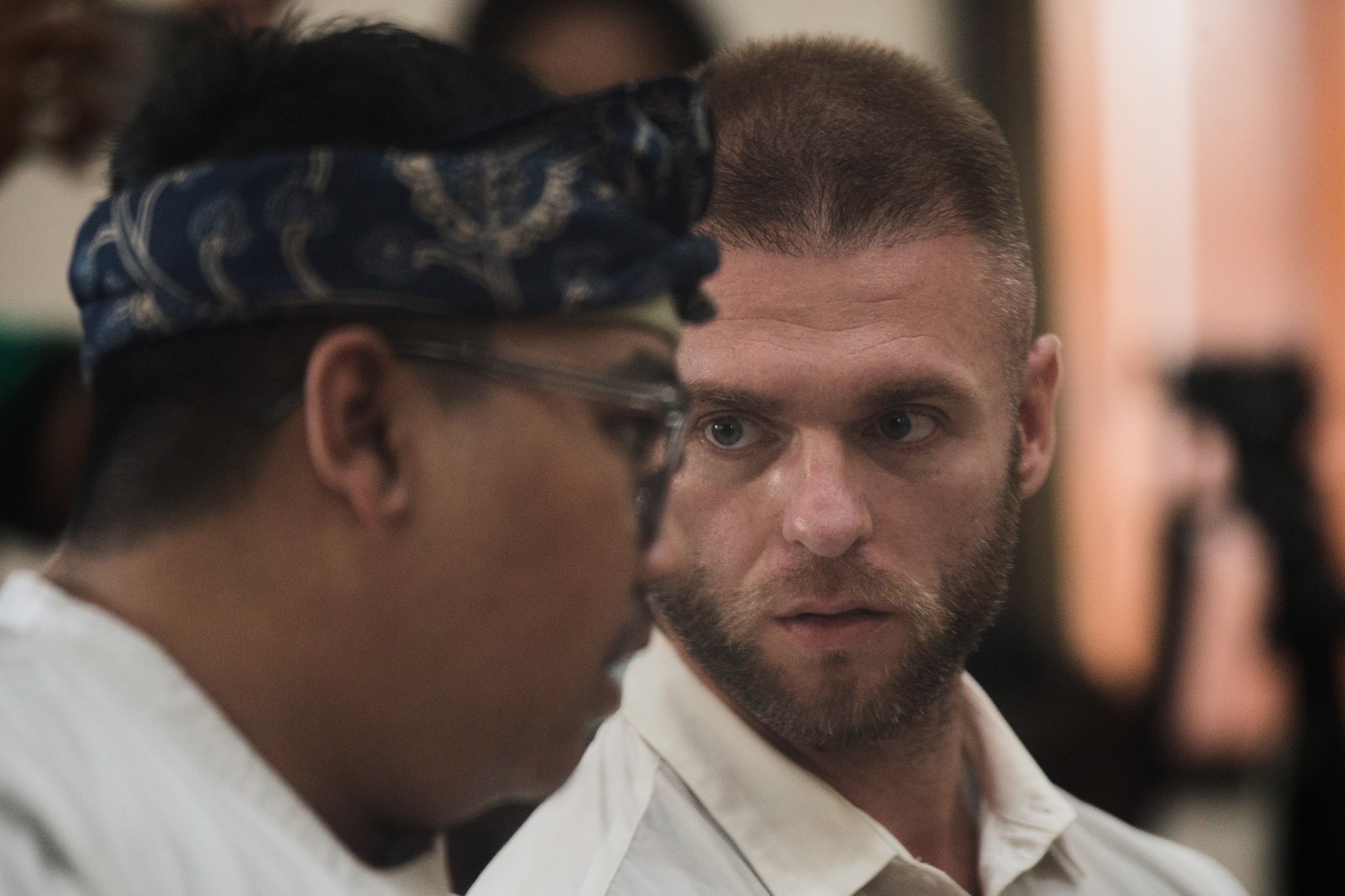 British citizen Thomas Parker sits on the defendant's chair before he is sentenced for drug crimes at Denpasar in Bali, Indonesia