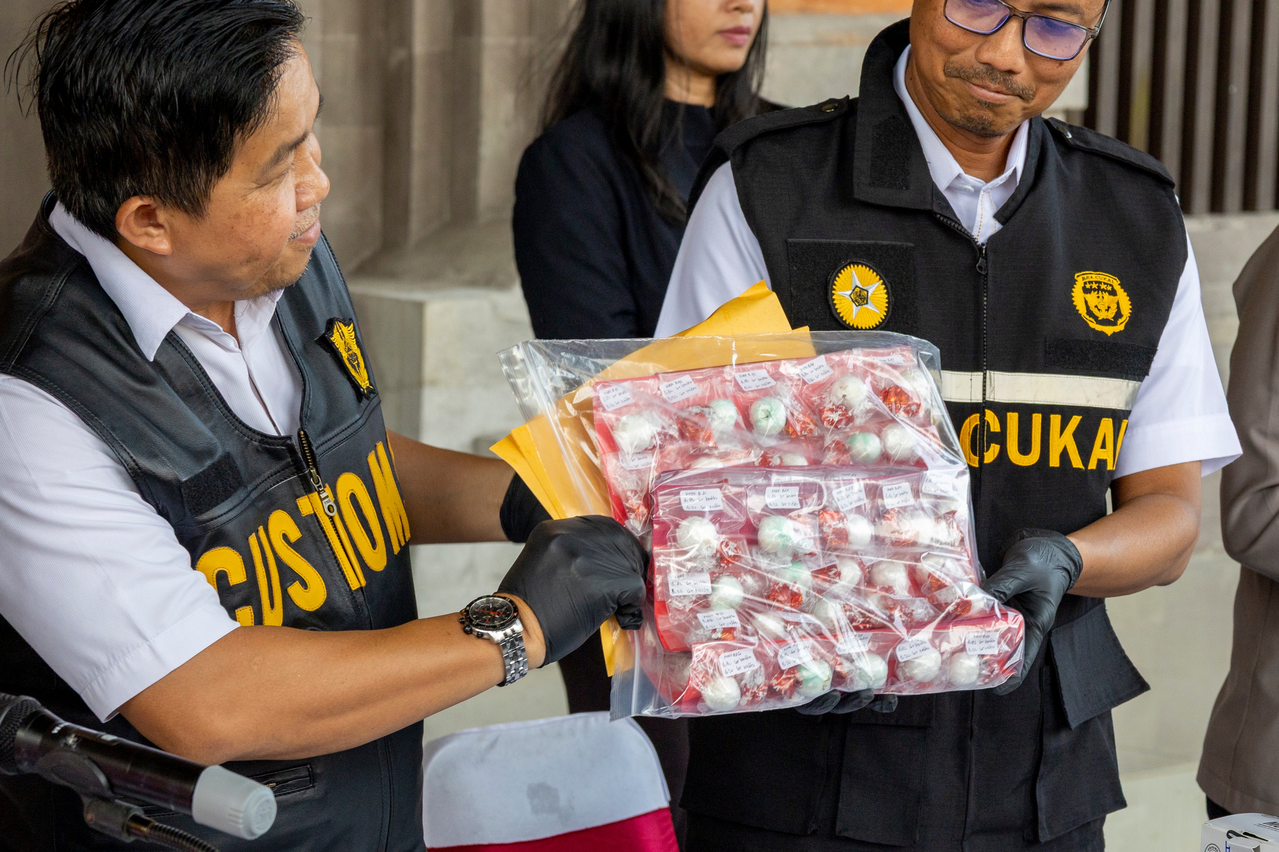 Officers display cocaine as evidence seized from an Australian man, Lamar Aaron Ahchee, identified by police with the initials LAA