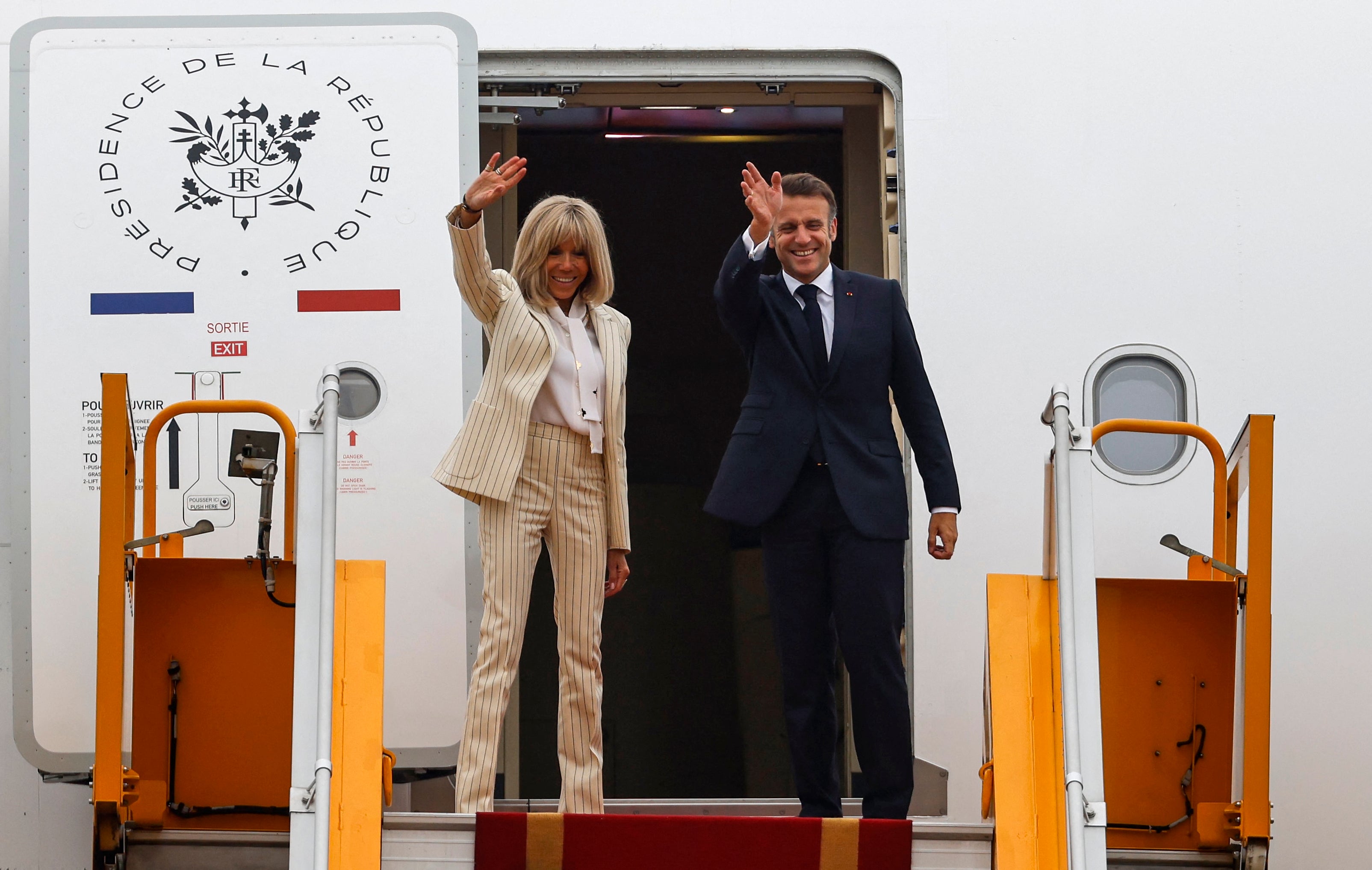 Emmanuel and Brigitte Macron put on a show of unity a they left Vietnam on Tuesday