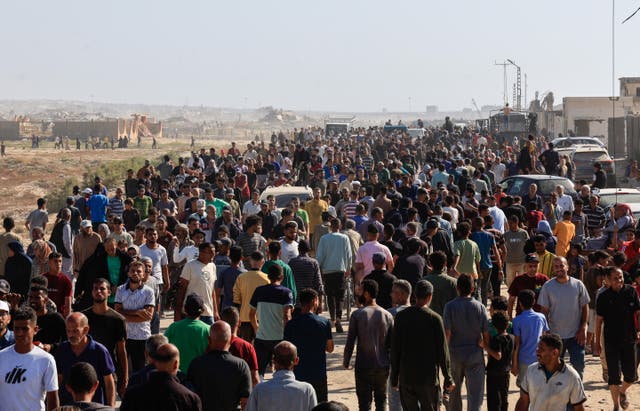 <p>Palestinians seeking aid gather near an aid distribution site run by the U.S.-backed Gaza Humanitarian Foundation, in Rafah, in the southern Gaza Strip, 27 May 2025</p>