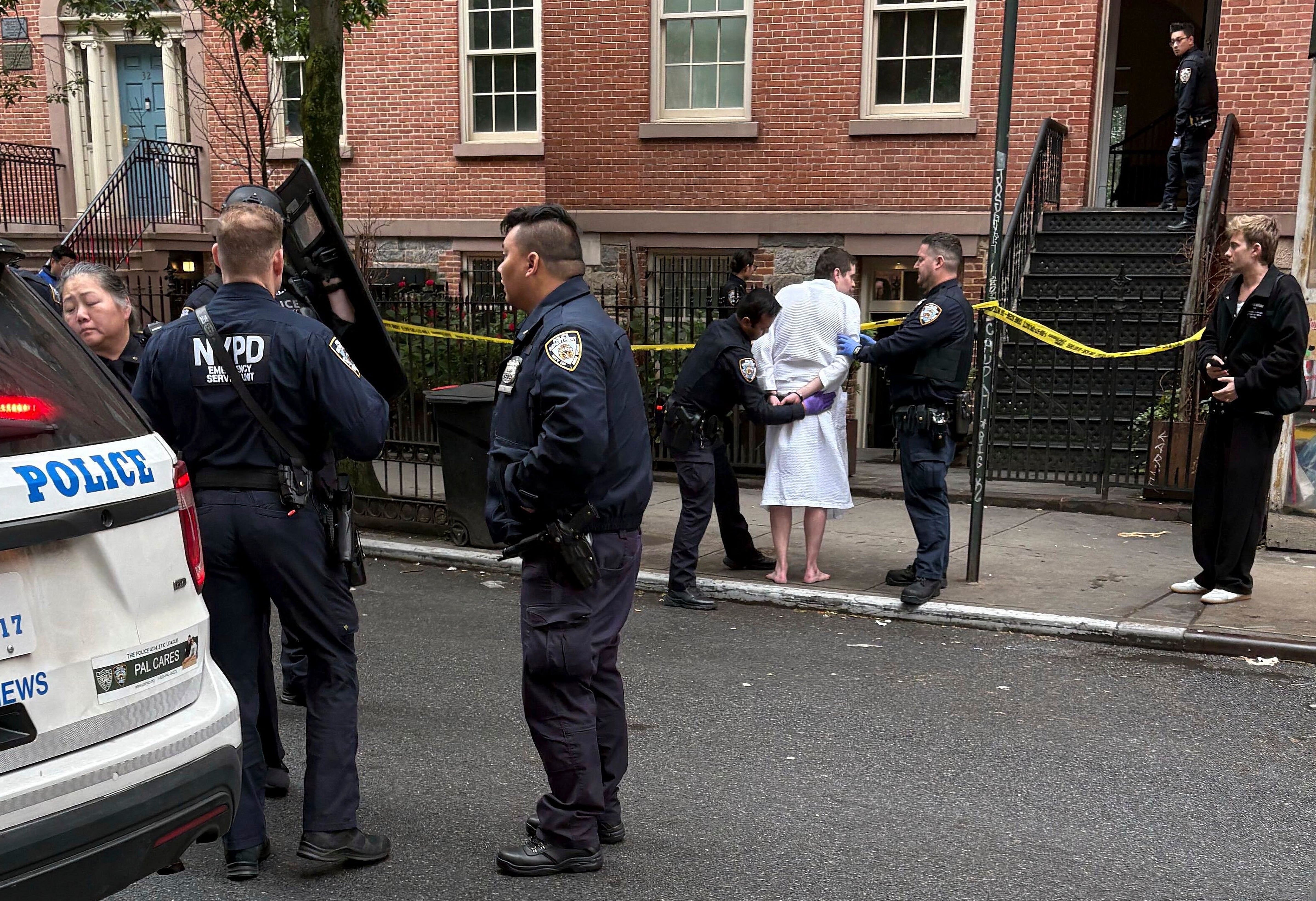 New York police officers arrest John Woeltz, Friday, May 23, 2025, in New York, who was charged with kidnapping, assaulting and holding a man against his will for several weeks in an upscale Manhattan town house