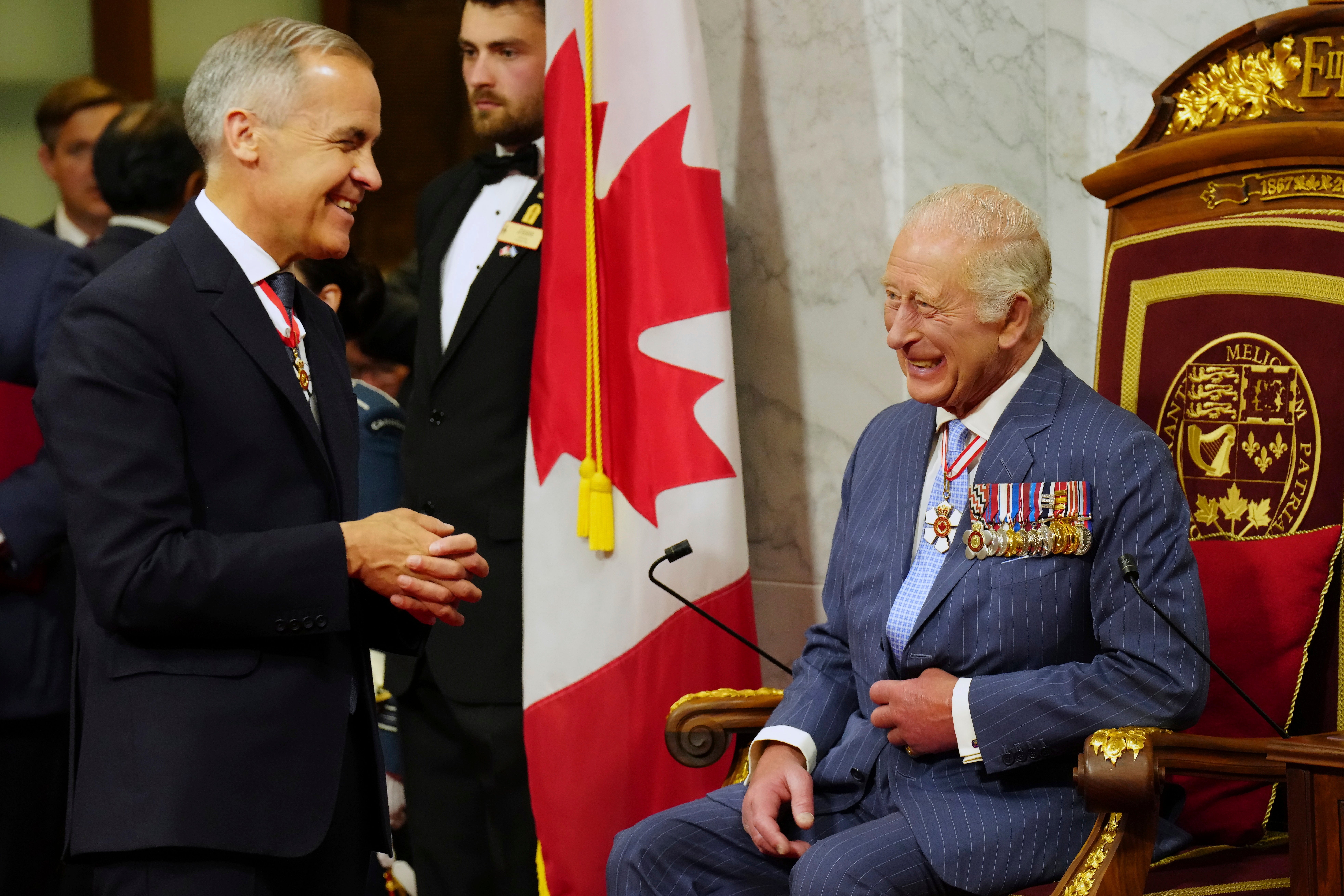 Canada Prime Minister Mark Carney, left, speaks with King Charles ahead of the King delivering the speech from the throne in the Senate in Ottawa, Canada on Tuesday, May 27, 2025.