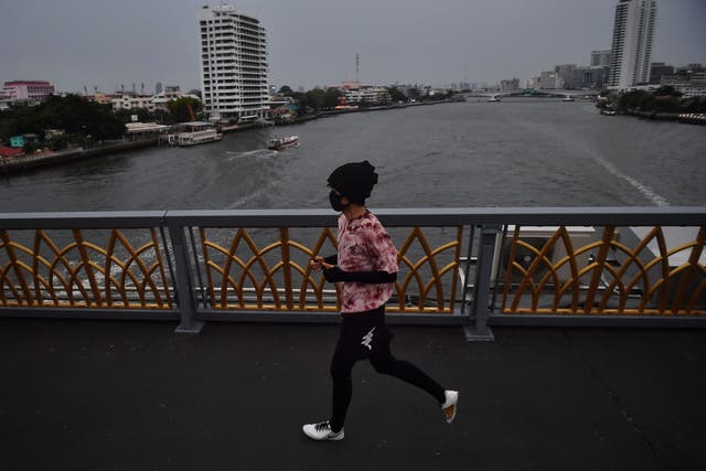 <p>Representative. A runner runs on a bridge crossing the Chao Praya River in Bangkok, Thailand</p>