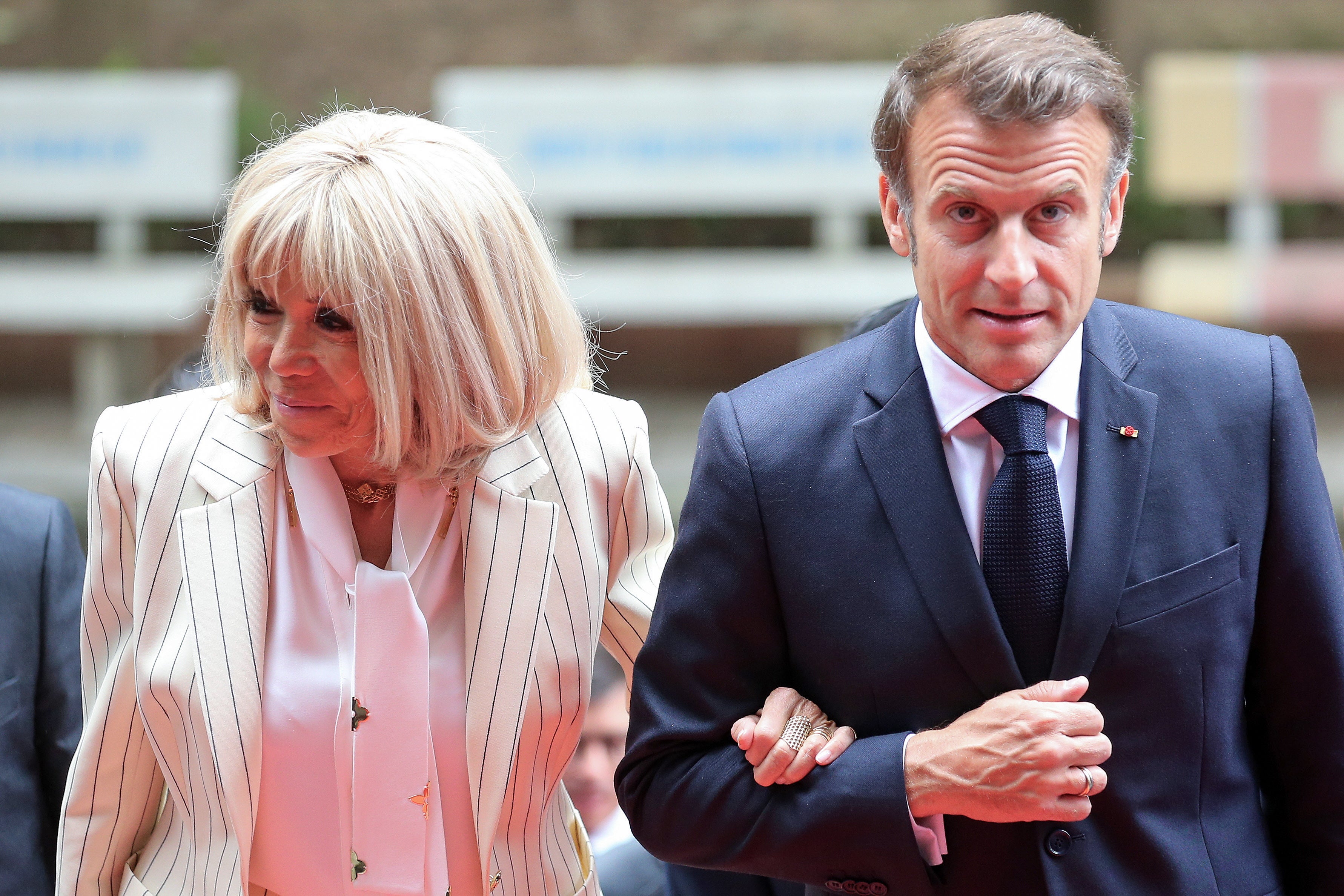 <p>Brigitte Macron was caught on camera shoving the French president in the face as they were about to leave their plane, having touched down in Vietnam</p>