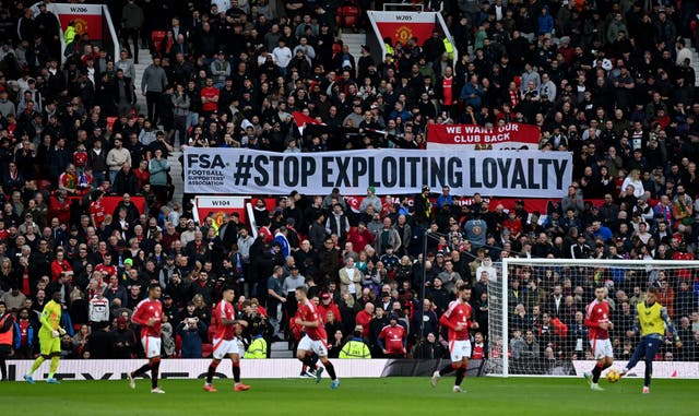 <p>Fans of Manchester United are seen with a ‘Stop Exploiting Loyalty’ banner in protest against ticket prices in December 2024</p>