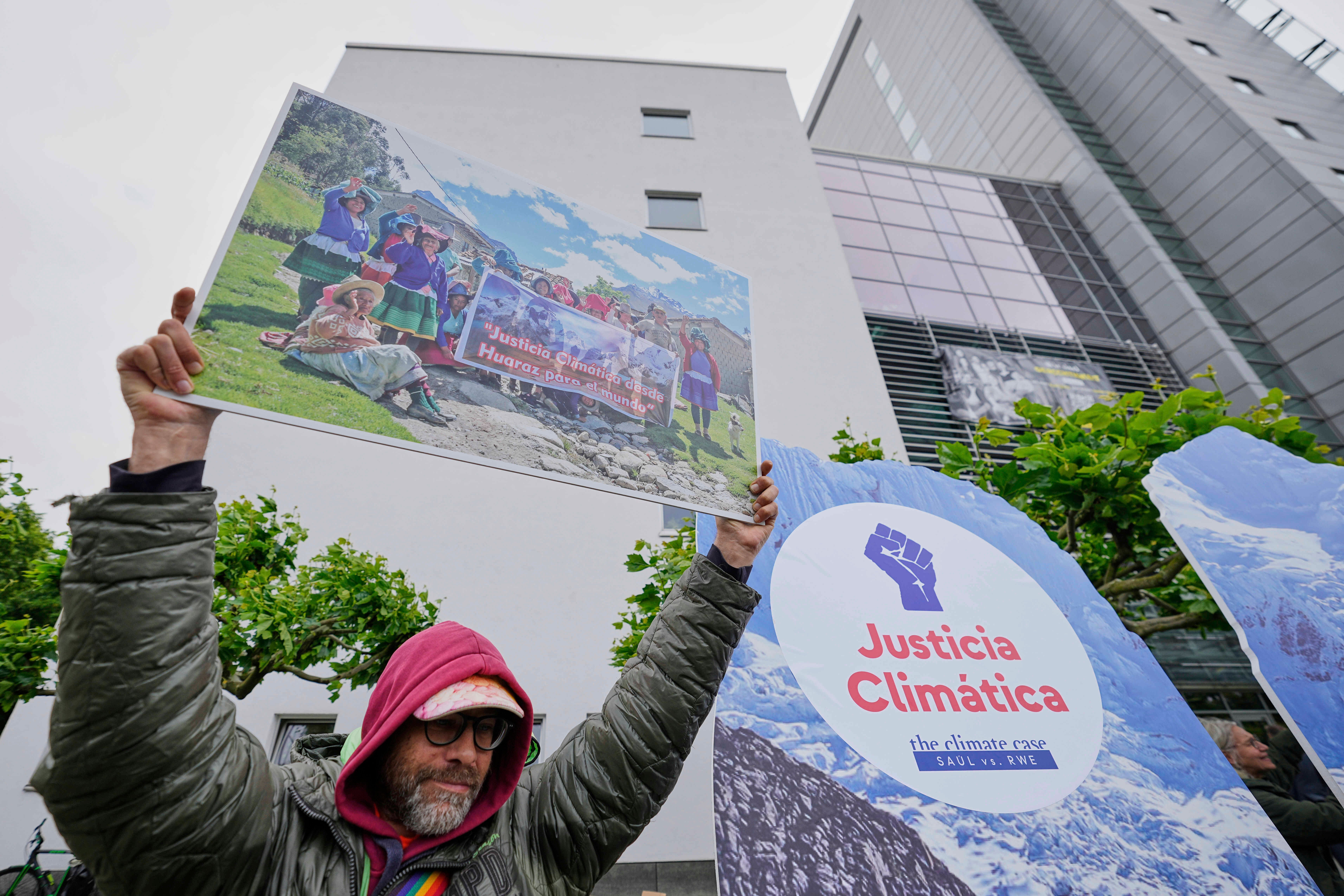A protester demands climate justice in front of the Higher Regional Court in Hamm, Germany