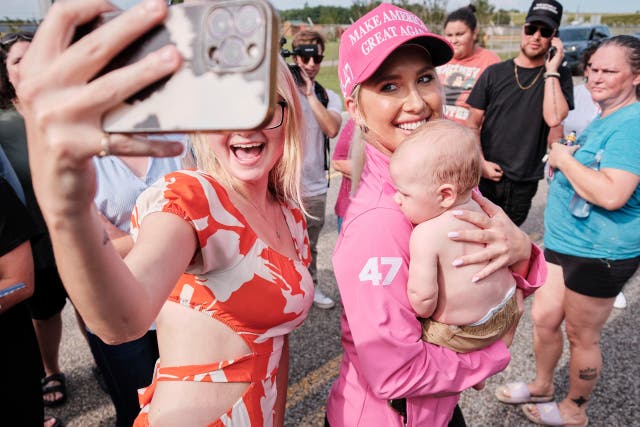 <p>A fan and her child pose for a photo with Savannah Chrisley, daughter of reality television star Todd Chrisley, after she spoke outside the Federal Prison Camp, Wednesday, May 28, 2025, in Pensacola, Fla. </p>