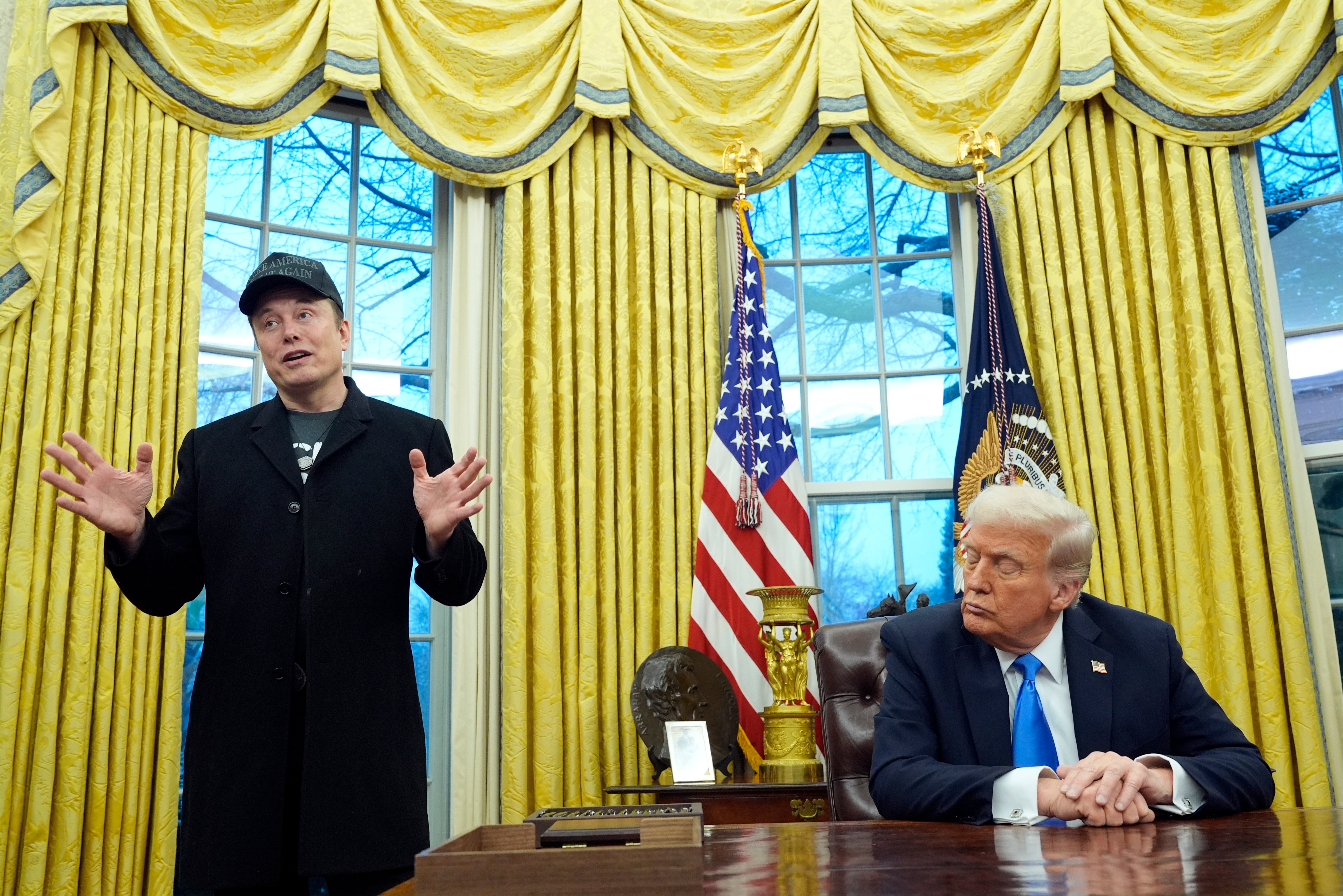 <p>President Donald Trump listens as Elon Musk speaks in the Oval Office at the White House</p>