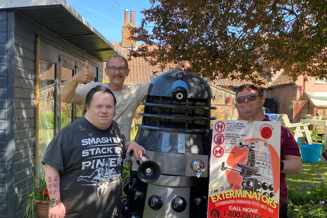 Mark Casto (back) with people at Waveney Enterprises and Dalek Doom, which they made together (Mark Casto/PA)