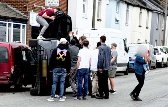 <p>The moment a group of heroic youngsters jumped into action to pull a young couple and a baby from a car after it flipped onto its side</p>