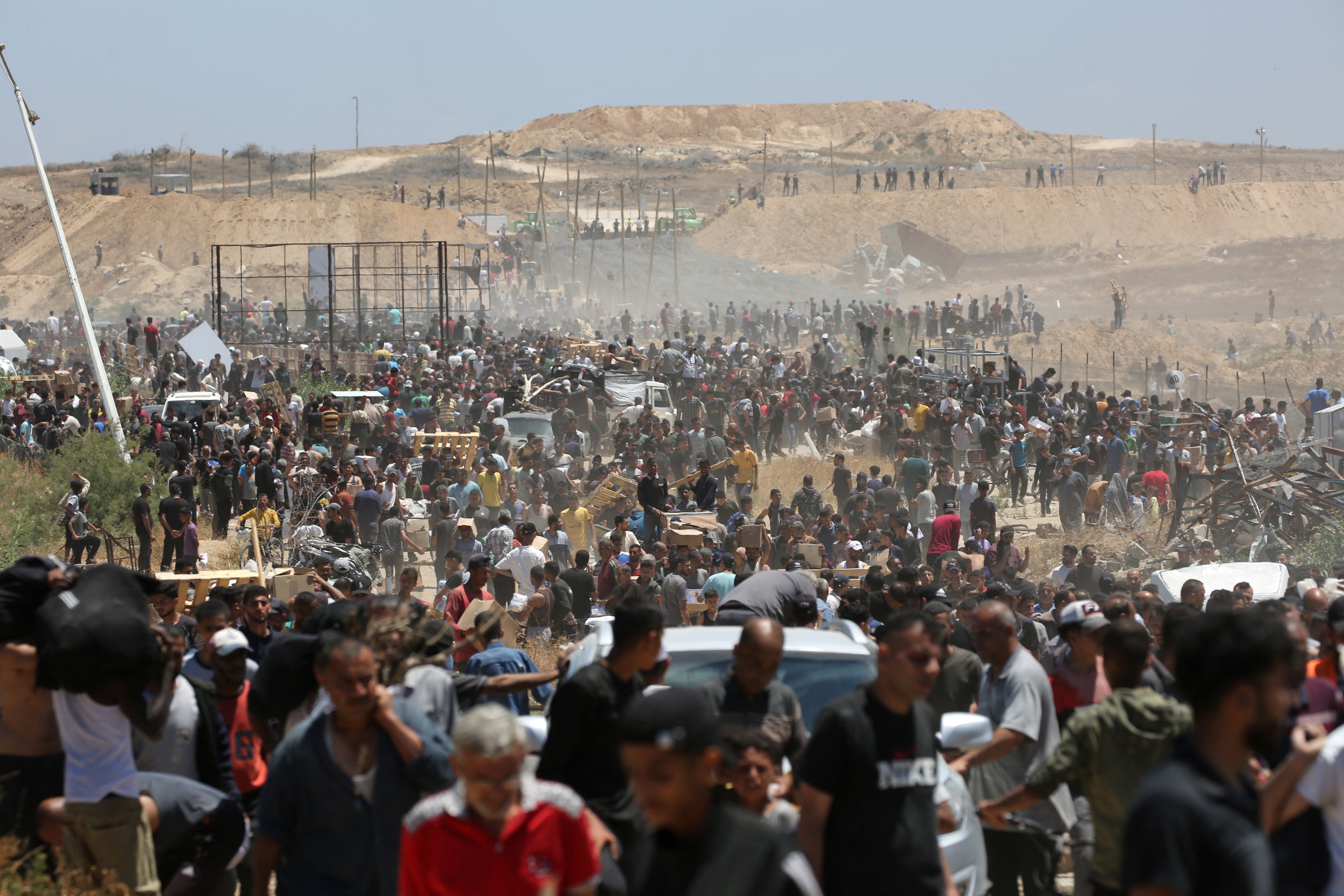 Palestinians carrying relief supplies return from an aid distribution centre in the central Gaza Strip on Thursday. A UN envoy said the aid was like ‘a lifeboat after the ship has sunk’