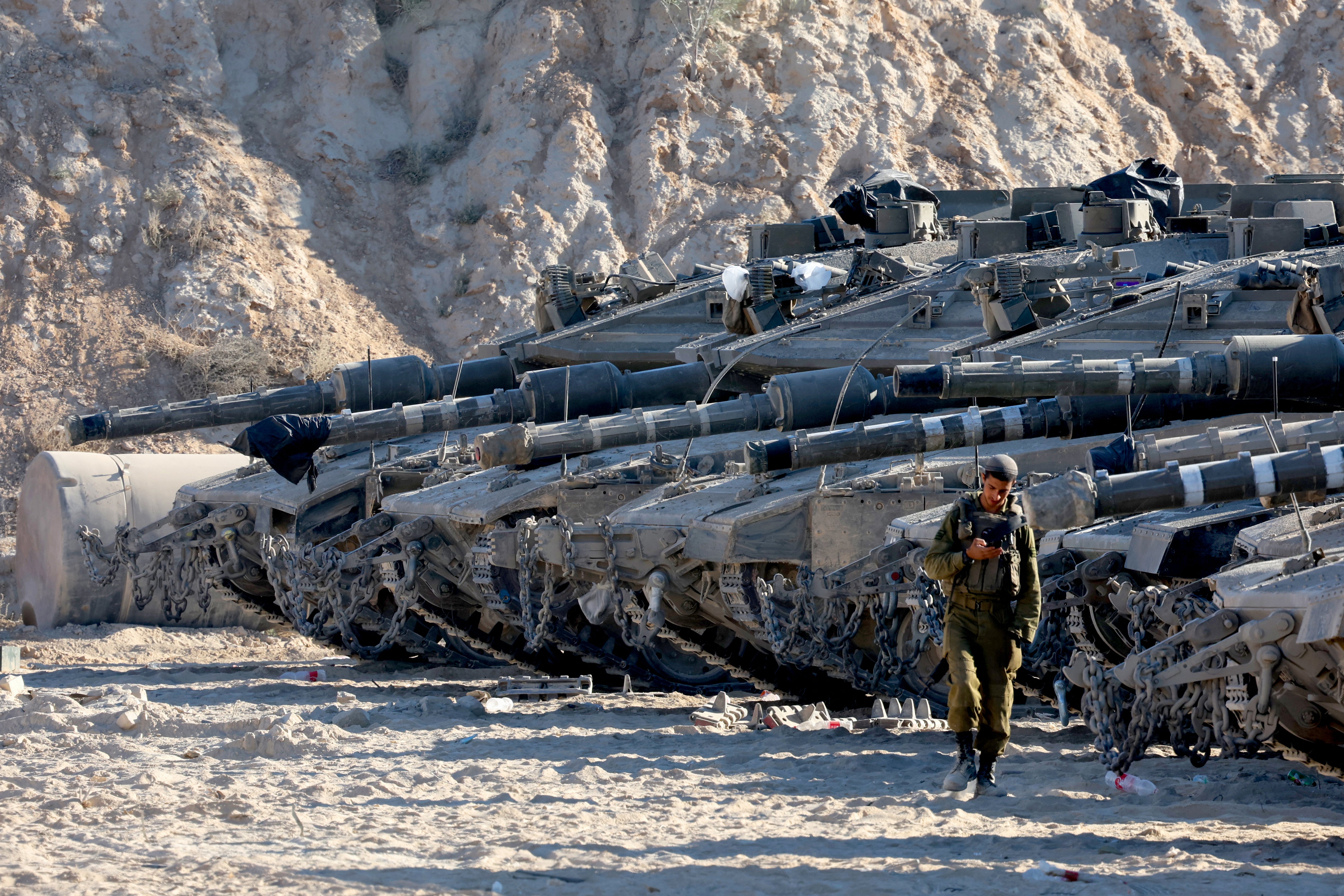 Israeli army tanks take position at the border between Israel and the Gaza Strip on Thursday