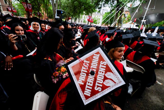 <p>A graduating student wears their hat, decorated with a statement of support for international students, during Harvard University’s commencement ceremonies on May 29 as a federal judge blocked the Trump administration from ending foreign student enrollment.</p>