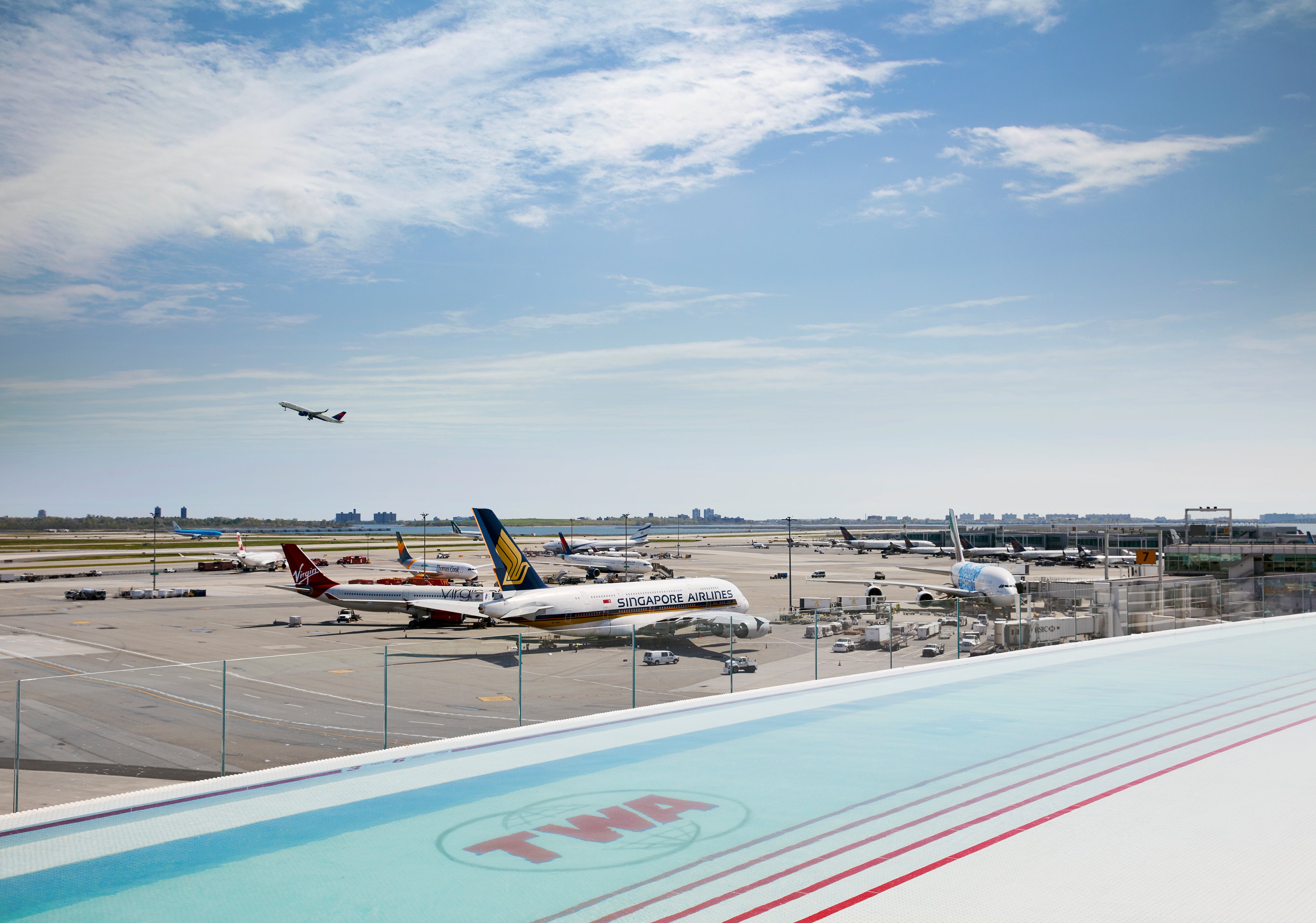 The TWA Hotel at JFK has a rooftop infinity pool that offers those splashing around a view of the ever-busy Runway 4 Left/22 Right