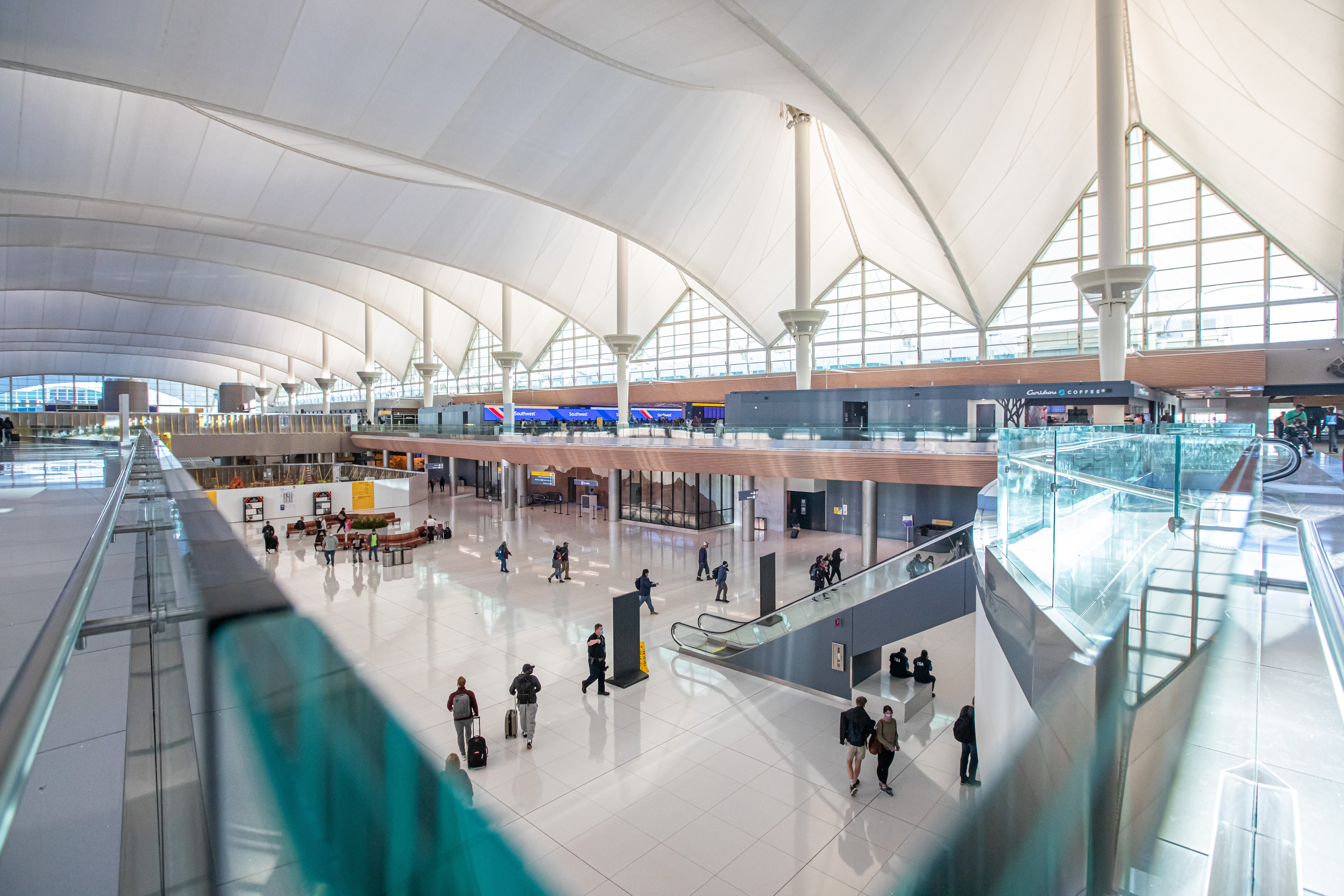 Above is Denver Airport's Jeppesen Terminal, with a tented roof designed to mimic the Rockies. 'Navigation isn't intuitive,' says Georgia