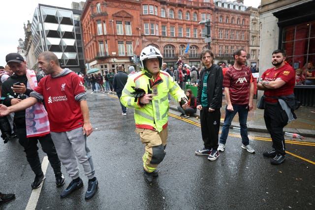 <p>Ben Ryder, area manager at Merseyside Fire and Rescue Service runs toward the scene of the crash in Water Street in Liverpool</p>
