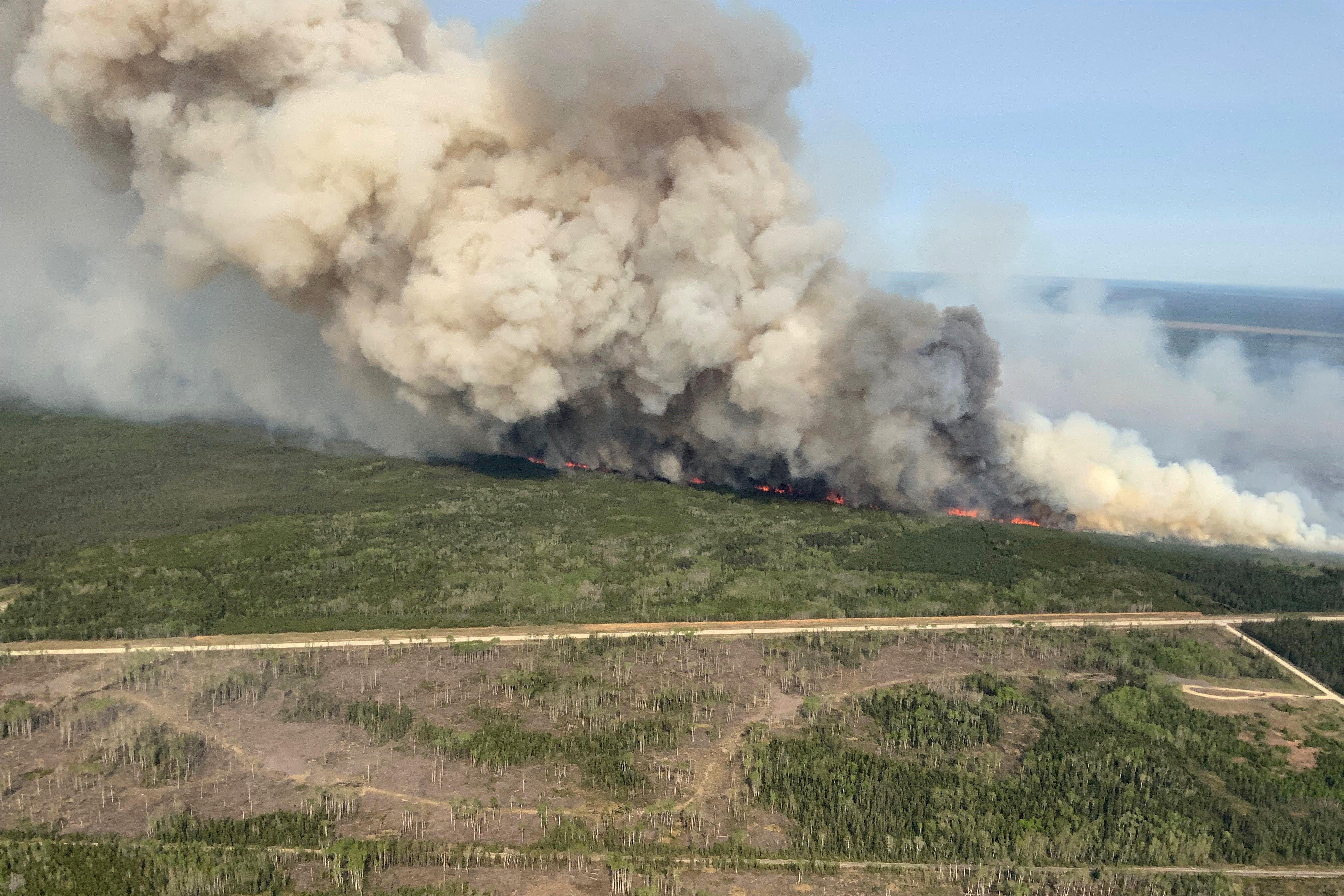 <p>Smoke rises from wildfire near Wanless, Manitoba, Canada </p>