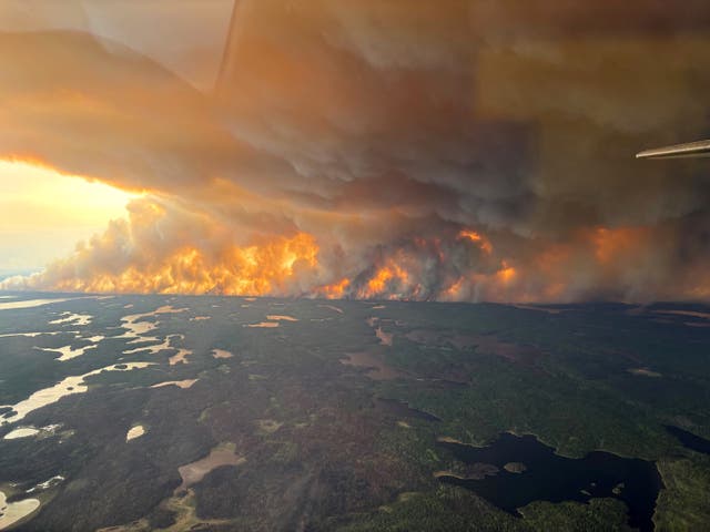 <p>Smoke rises from a wildfire in Flin Flon, Manitoba, Canada </p>