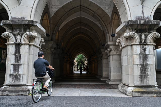<p>File. A man rides a bicycle at the University of Tokyo in Japan</p>